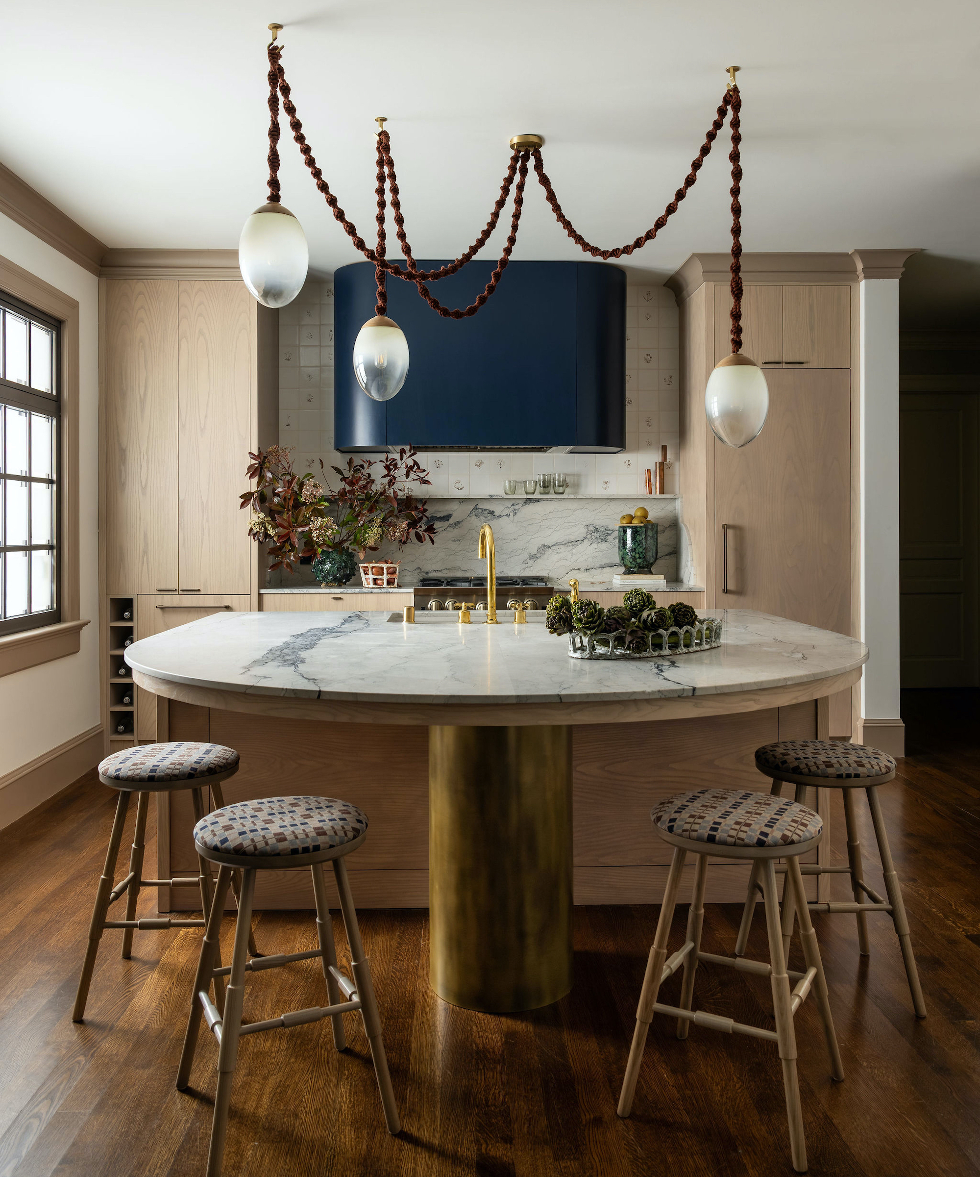 kitchen with island with curved end and four stools