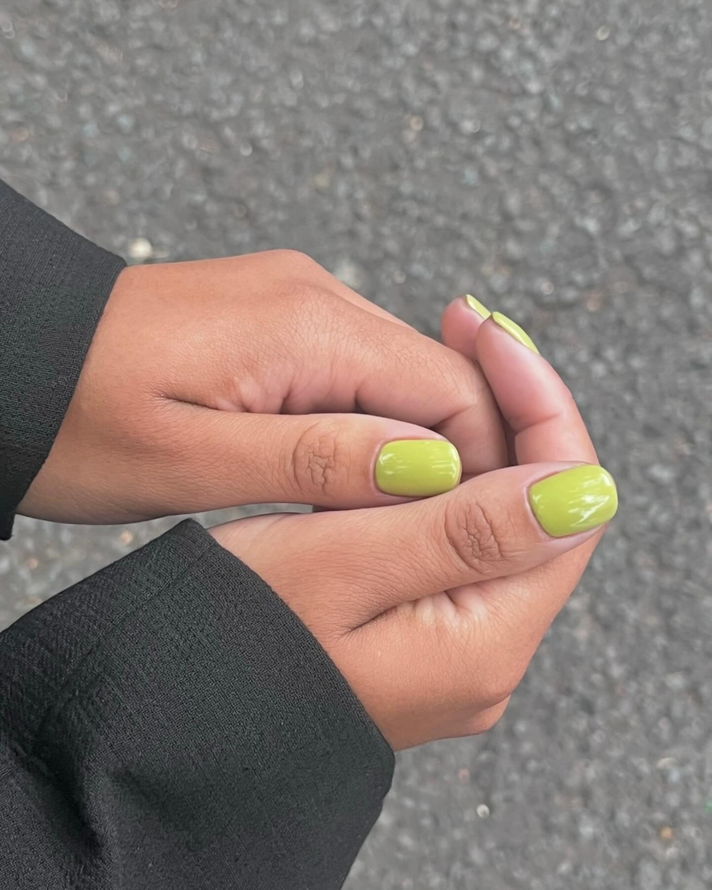 A dark pistachio green manicure