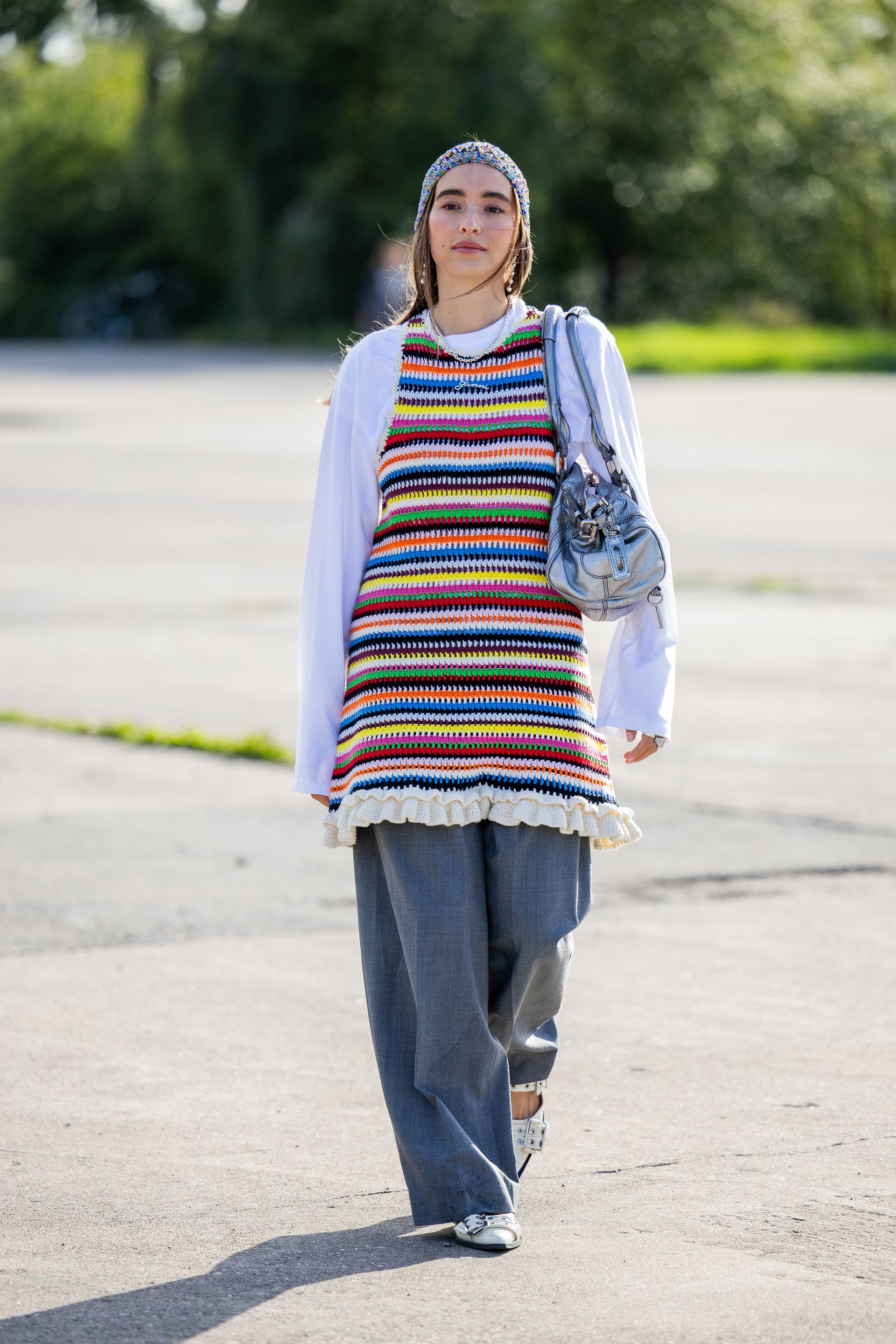 Photo of Scandi woman wearing rainbow knit mini dress over jeans during Copenhagen Fashion Week.