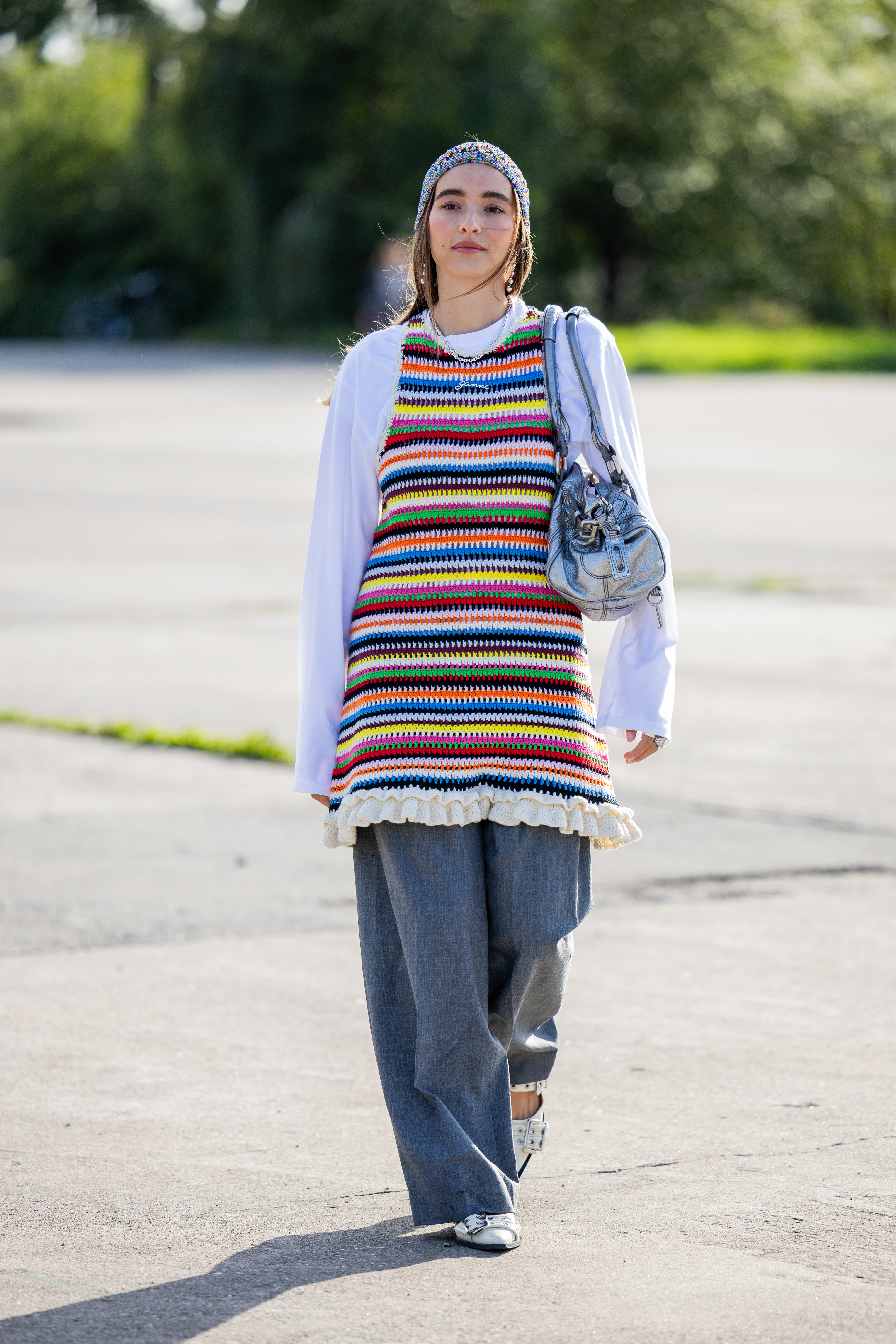 Photo of Scandi woman wearing rainbow knit mini dress over jeans during Copenhagen Fashion Week.