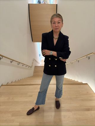 Irene Chen wearing a navy blazer with jeans and loafers.