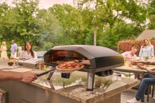 Ooni's Koda 2 Max in a backyard with 2 Neapolitan style pizzas