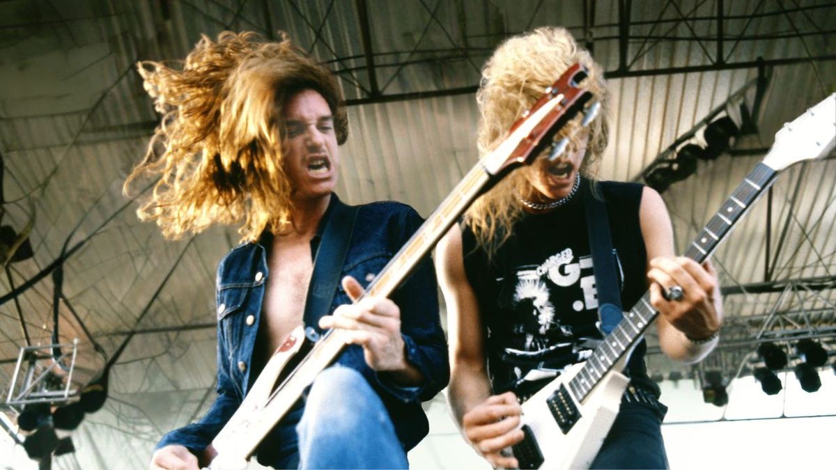 Photo of METALLICA and Cliff BURTON and James HETFIELD; Cliff Burton (playing Rickenbacker bass) and James Hetfield (playing Gibson Flying V guitar) performing live onstage 