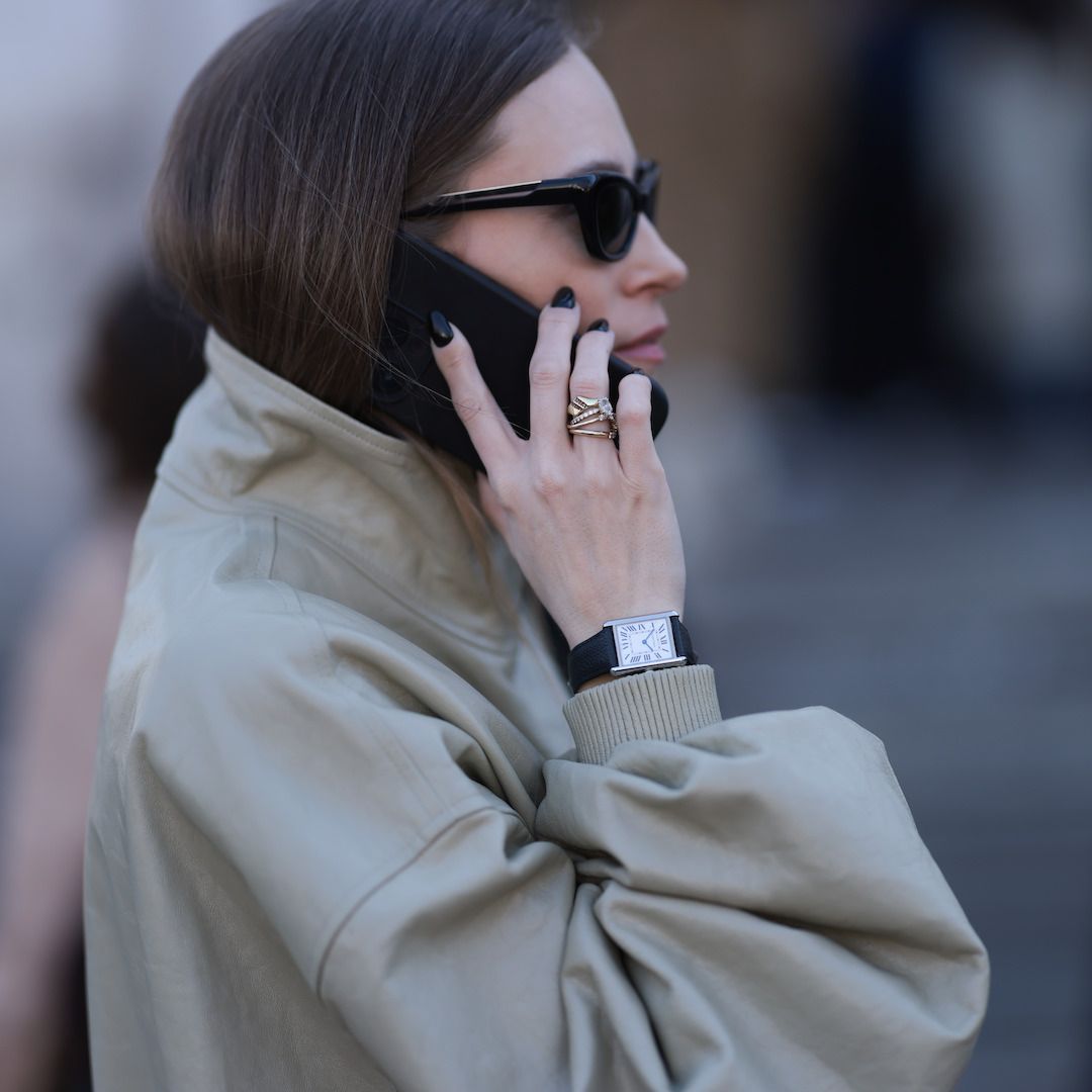 woman wearing trench with black nail polish