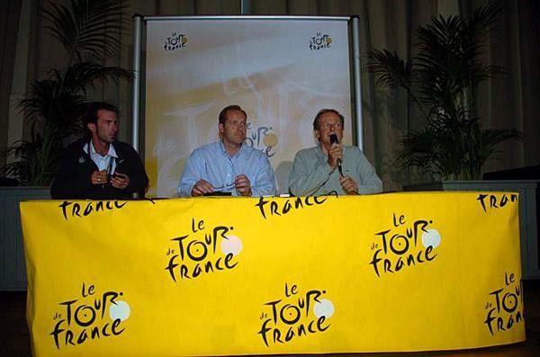 Christian Prudhomme (center) and Patrice Clerc (with microphone) field questions from the press.