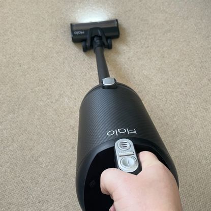 Black Halo Capsule XR Cordless Vacuum Cleaner being used on cream carpet