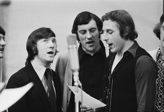 Arsenal footballers in a recording studio in London, UK, to record the single 'Good Old Arsenal', April 1971. They sang the song at the 1971 FA Cup Final in May. From left to right, George Armstrong, Ray Kennedy and John Radford. (Photo by Les Lee/Daily Express/Getty Images)