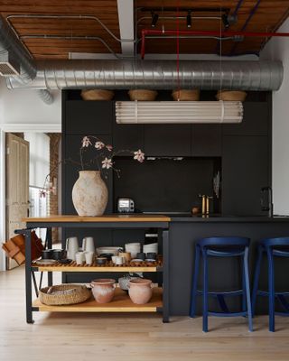 a loft apartment kitchen with industrial ducting