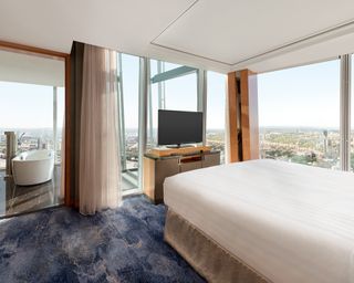 Shard suite inside the Shangri La, The Shard with bed, mattress, TV, bath and panoramic view of London