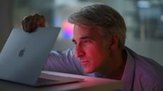 Apple's Craig Federighi opens a MacBook Air laptop at Apple's November 2020 Apple silicon launch event.