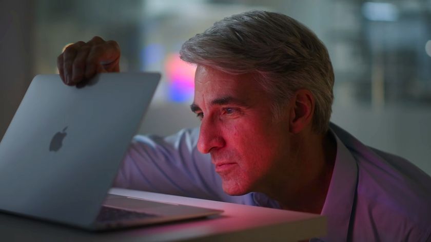 Apple&#039;s Craig Federighi opens a MacBook Air laptop at Apple&#039;s November 2020 Apple silicon launch event.