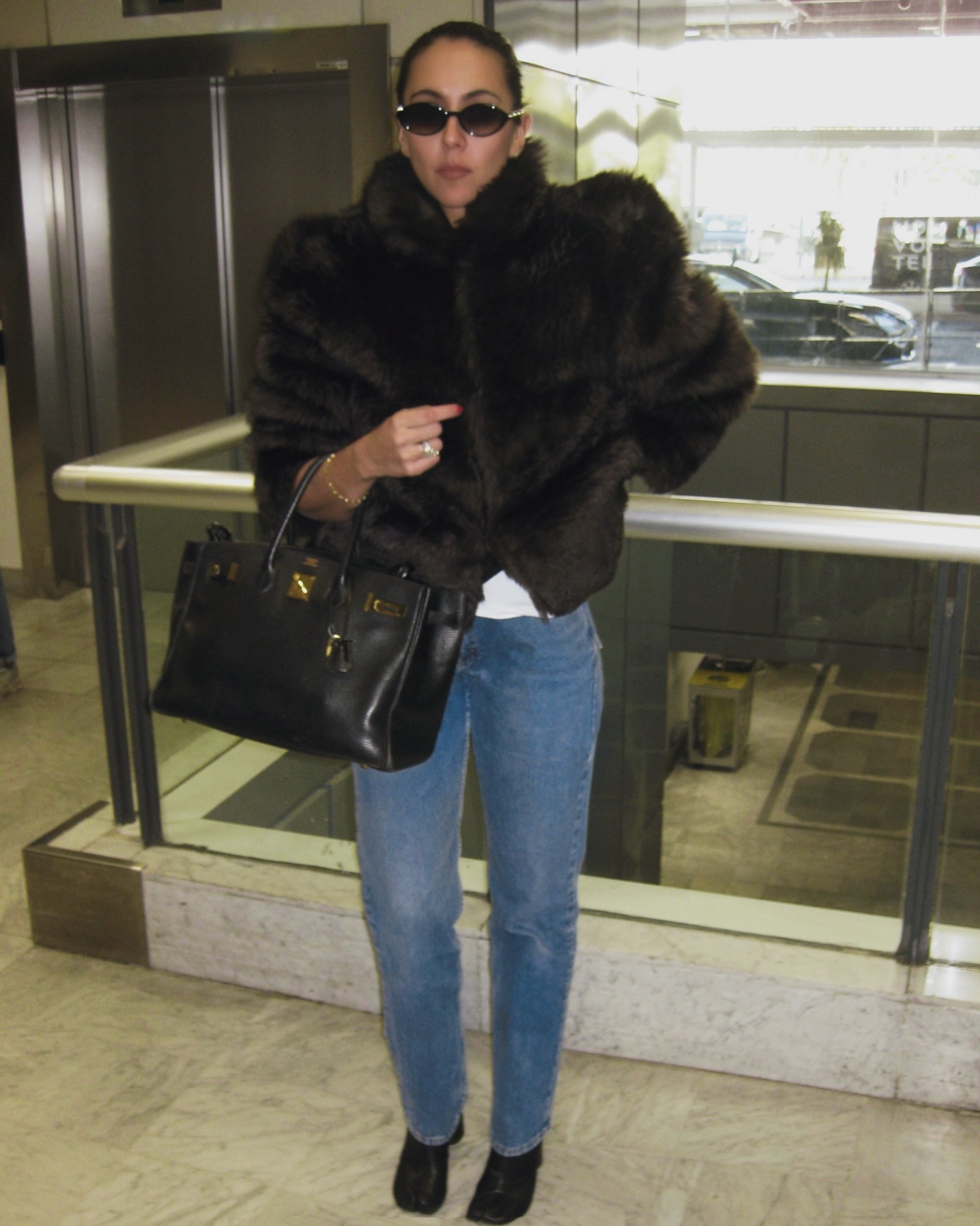 Influencer wearing jeans and a cropped fur coat