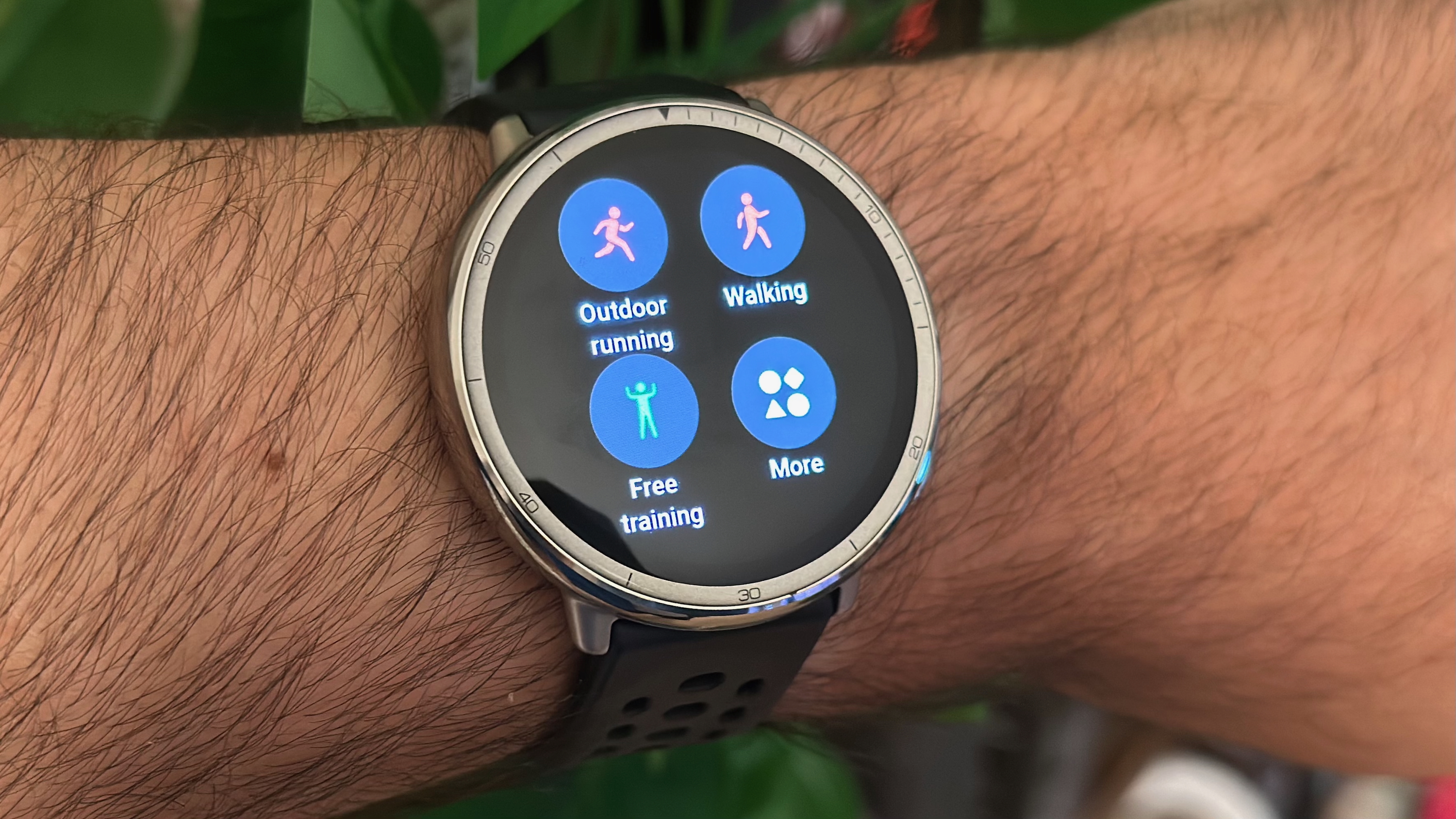 A photo of the Amazfit Active 2 on a wrist, showing different sports mode button icons.