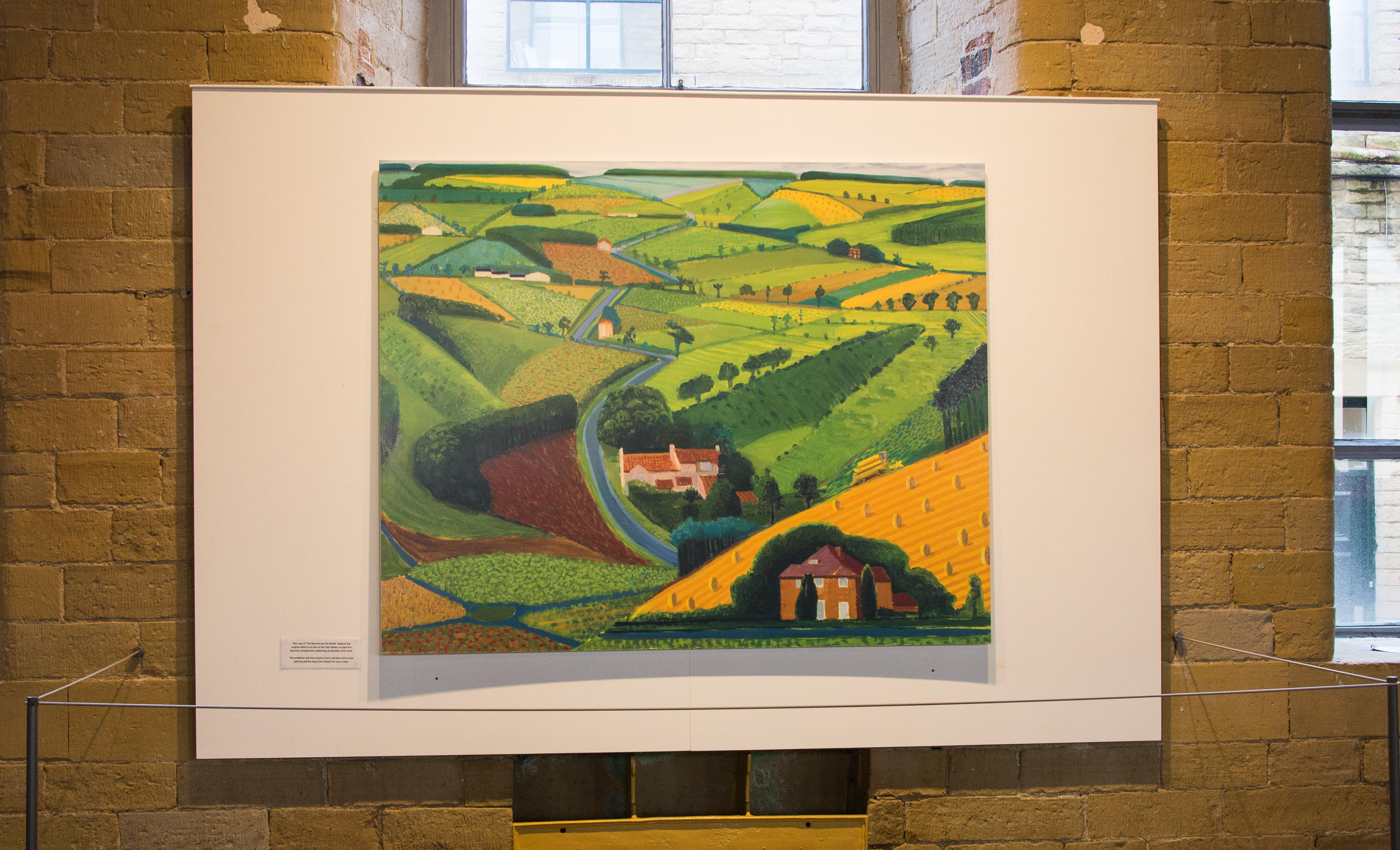 A David Hockney print of 'The Road Across the Wolds'.