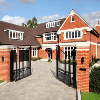 house with red brick and black gate