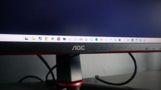 The AOC Gaming CQ27G2S/BK photographed on a desk.