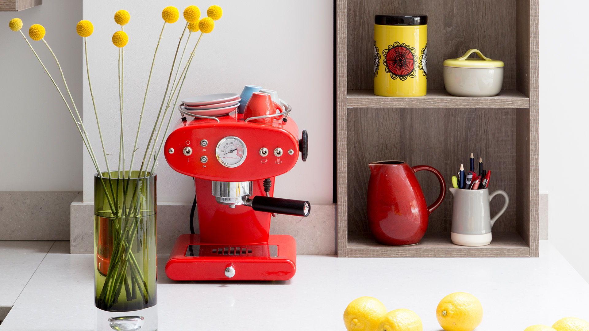 neutral kitchen with a red espresso coffee machine on display