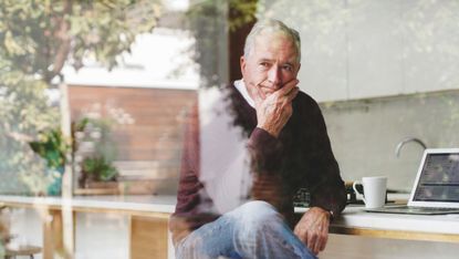 Senior businessman at kitchen table thinking