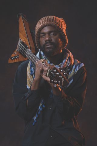 Gary Clark Jr. poses with one of his Gibson GCJ Flying Vs with three Gibson Custom Shop P90s