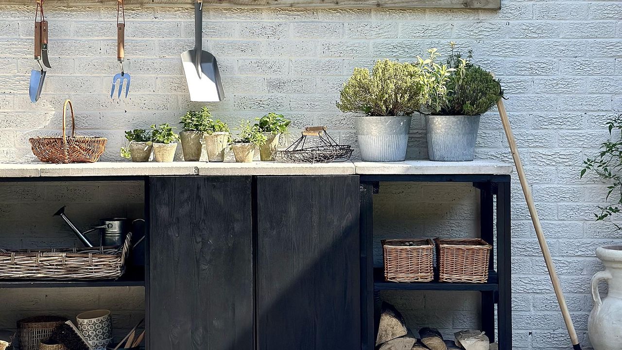 potting station in garden with potting table and plants