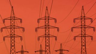 Energy pylons against a blood-red sky