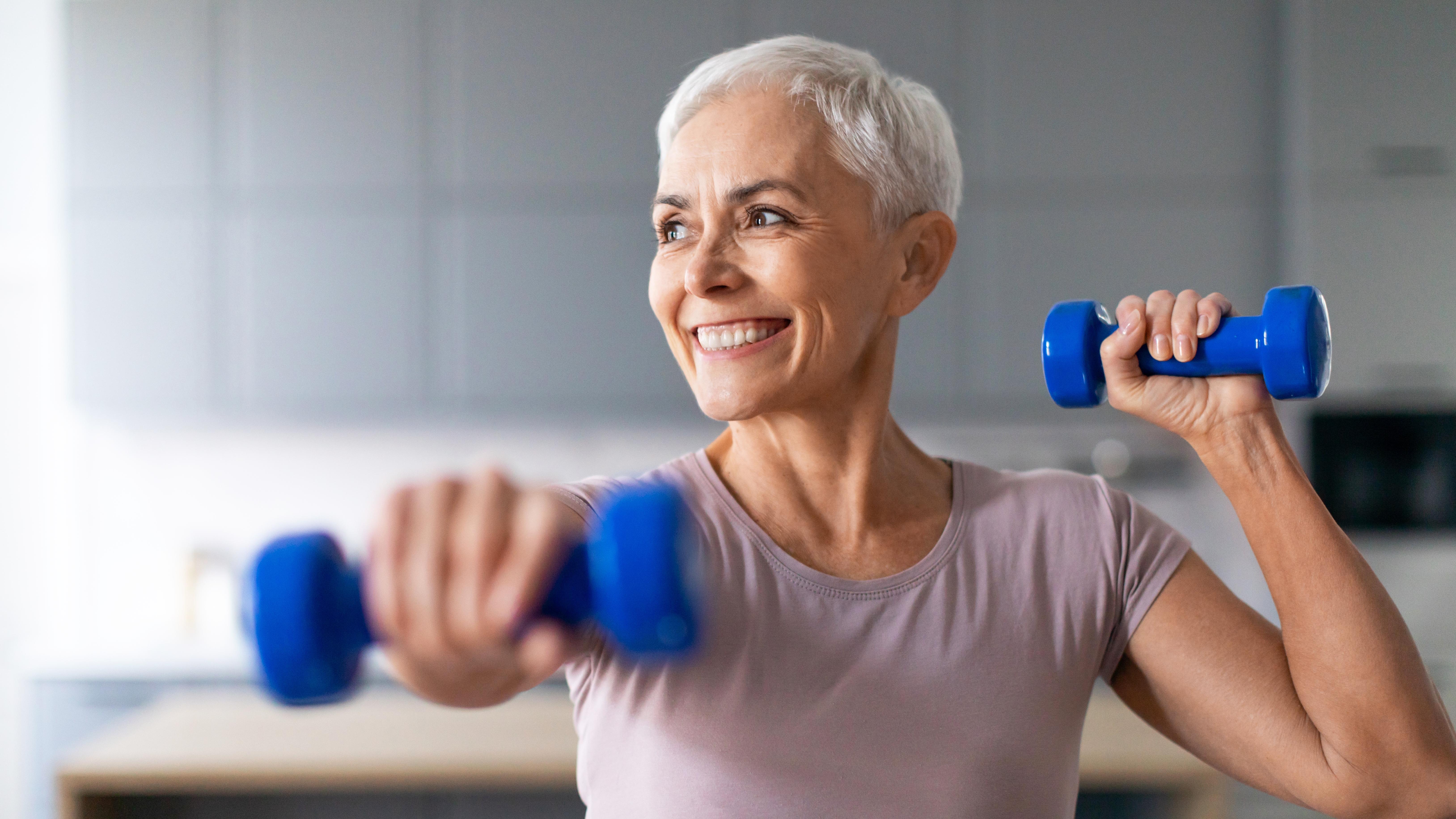 a senior woman exercising with dumbbells