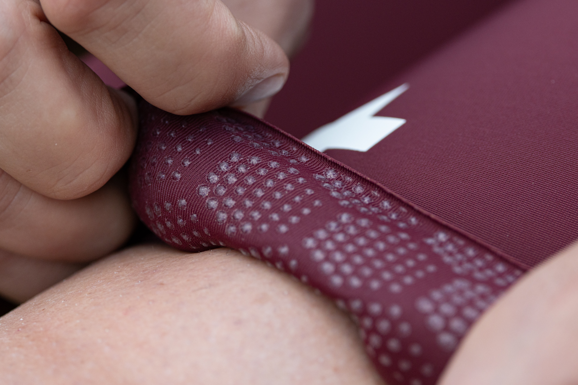 close up of the silicone dots on the inside of the hem of a pair of red cycling shorts