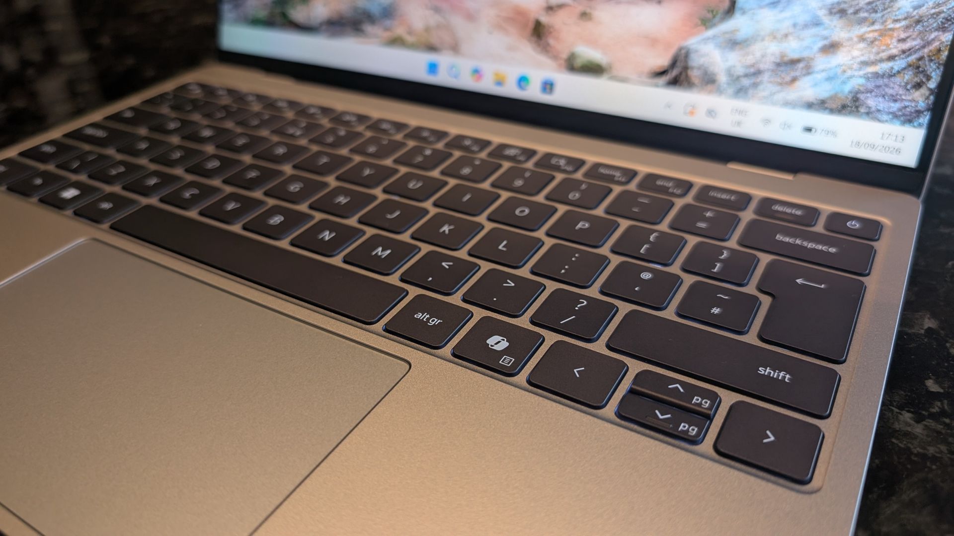 The Dell XPS 13 (2026) laptop pictured on a black marble worktop.
