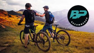 Two mountain bikers having a chat in the mountains