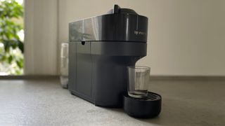 The Nespresso Vertuo Pop with a shot glass sat on it