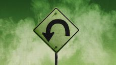 Photo collage of a green U-turn sign on a smoky background