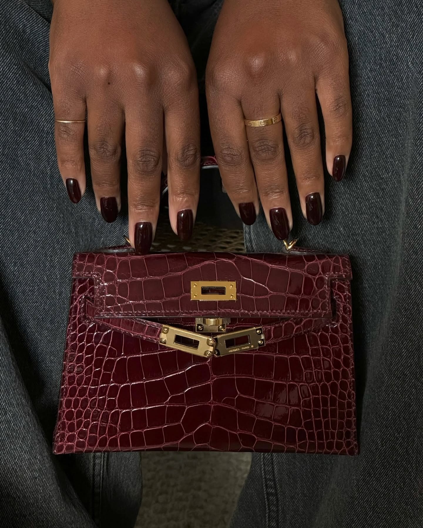 Long dark red nails with a brugundy Hermes Kelly bag in dark red