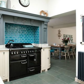 kitchen area with black cooker with oven and white wall