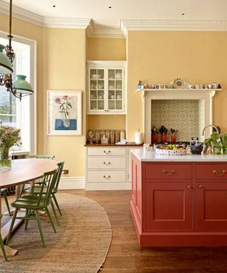Kitchen with yellow walls and red painted island