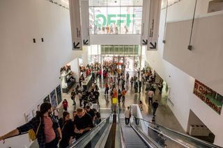 OFFF Barcelona people coming up the escalator with OFFF logo in the background