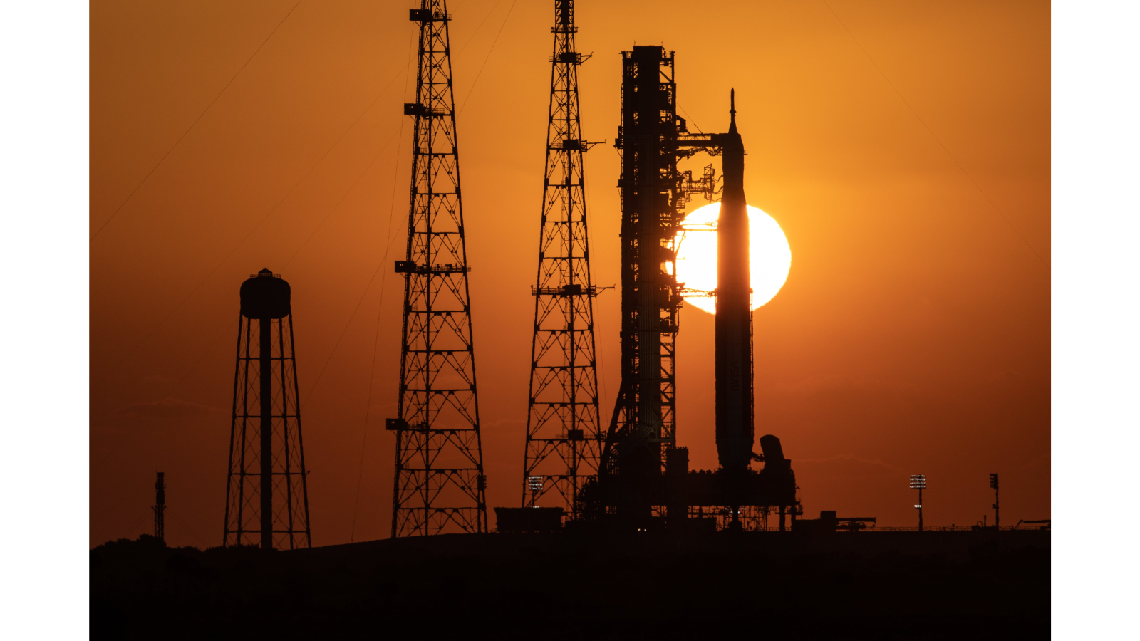 The Artemis 1 stack is backdropped by the rising sun on March 18, 2022, after its first-ever rollout to the launch pad.