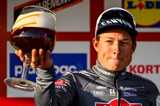 Alpecin-Deceuninck team Belgium's Jasper Philipsen celebrates on the podium after winning the Kuurne-Brussels-Kuurne one day cycling race, 196,9 km from Kuurne to Kuurne via Brussels, on March 2, 2025. (Photo by ERIC LALMAND / Belga / AFP) / Belgium OUT