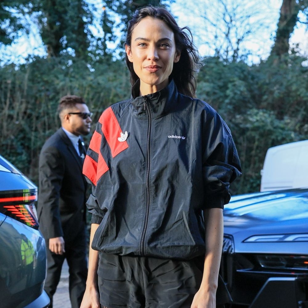 Alexa Chung wears a windbreaker jacket with lace-trim shorts and Miu Miu buckle heels.