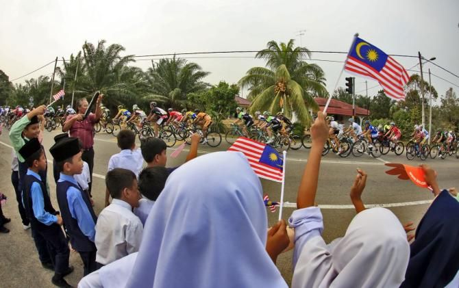 The crowds cheer on the riders