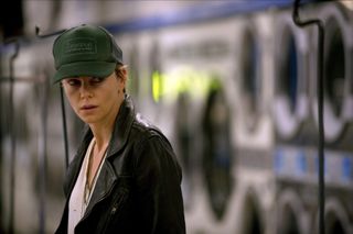 Libby Day (Charlize Theron) shoots a guarded stare to someone offscreen in Dark Places