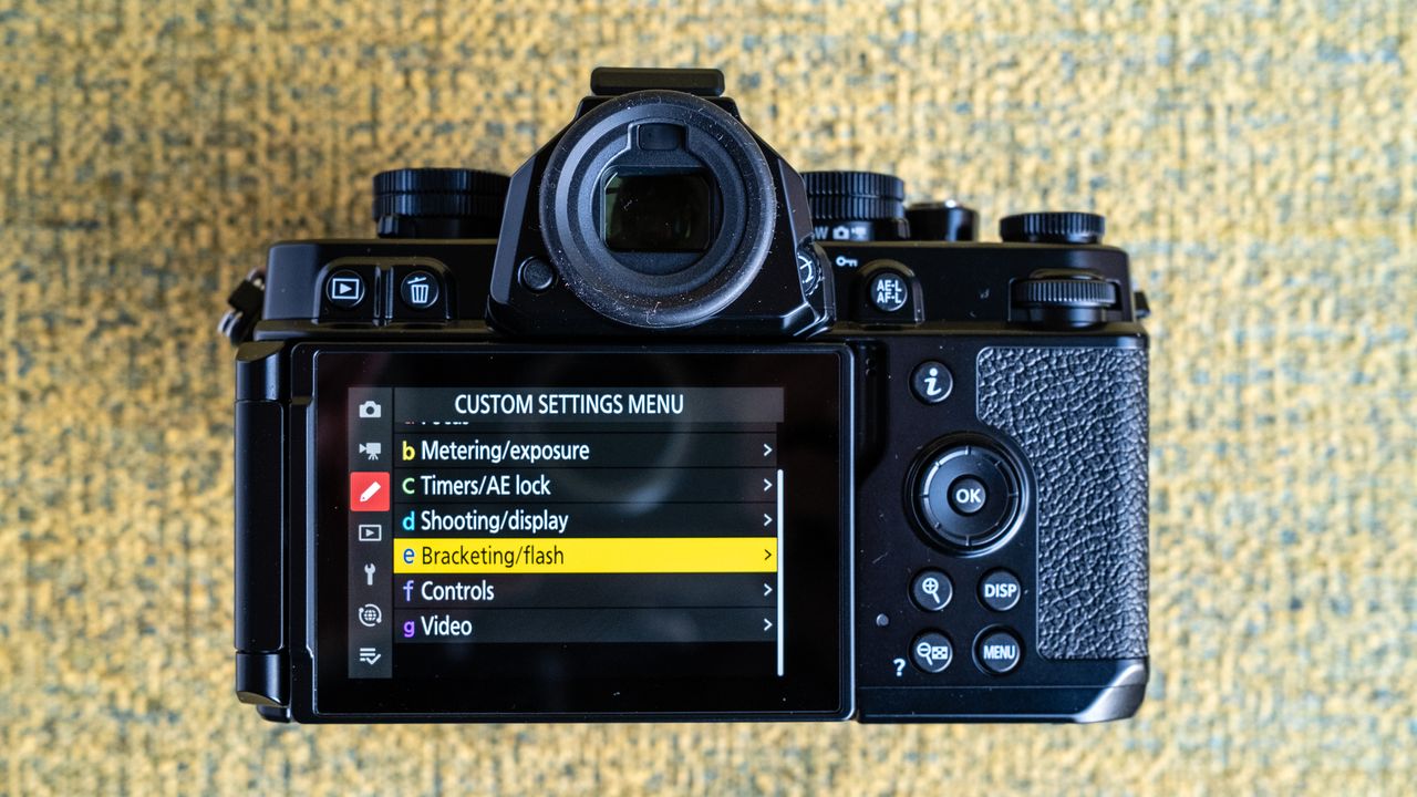 Nikon Z f camera on a vintage-style yellow chair