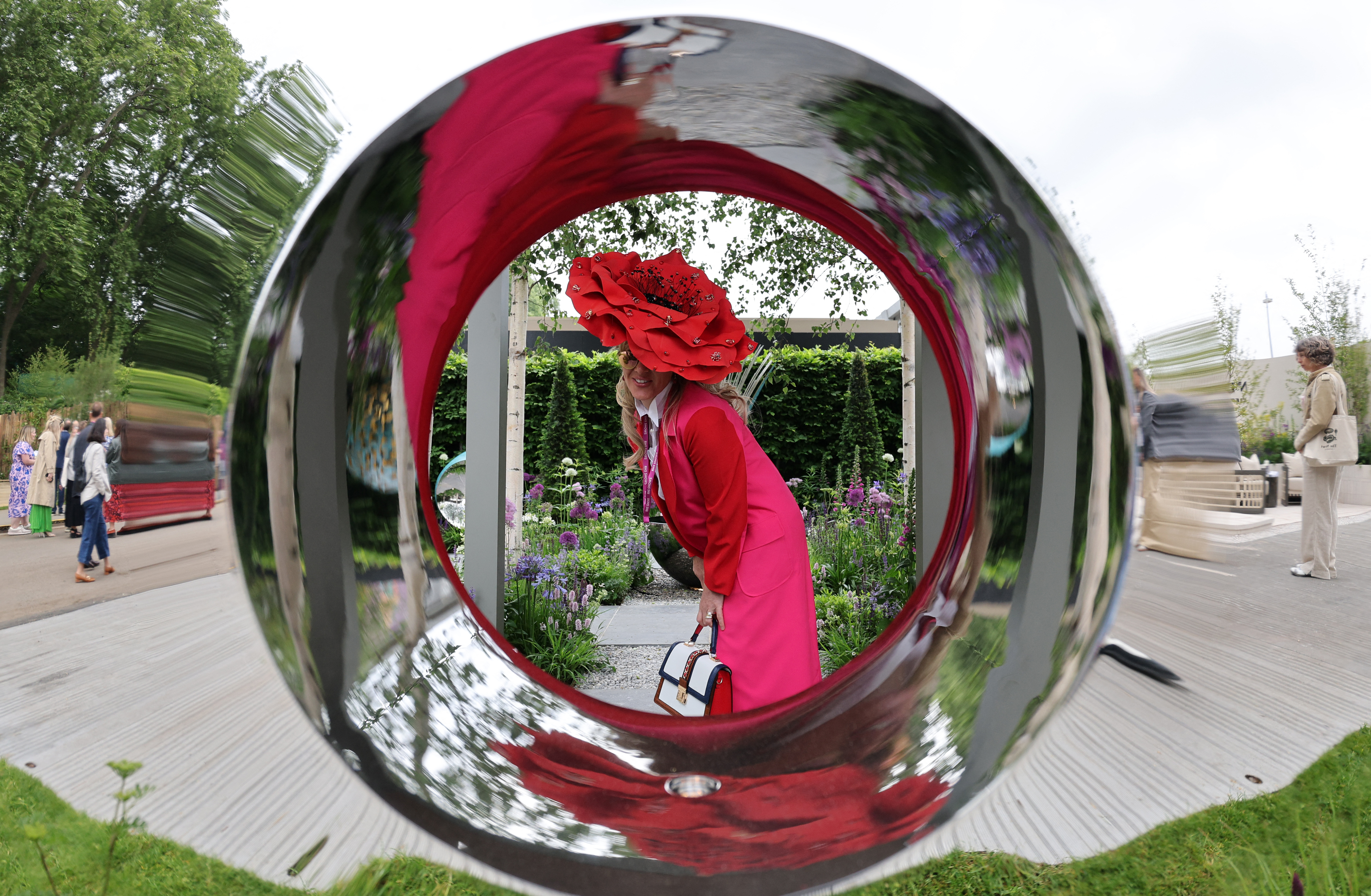 Fellow of the RHS, Laura Konig poses with her Poppy Hat in David Harber garden during the preview day at the RHS Chelsea Flower show, in London, on May 19, 2025
