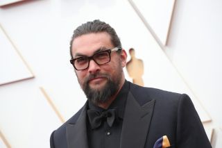 Jason Momoa wearing a black bow tie and glasses at the Academy Awards