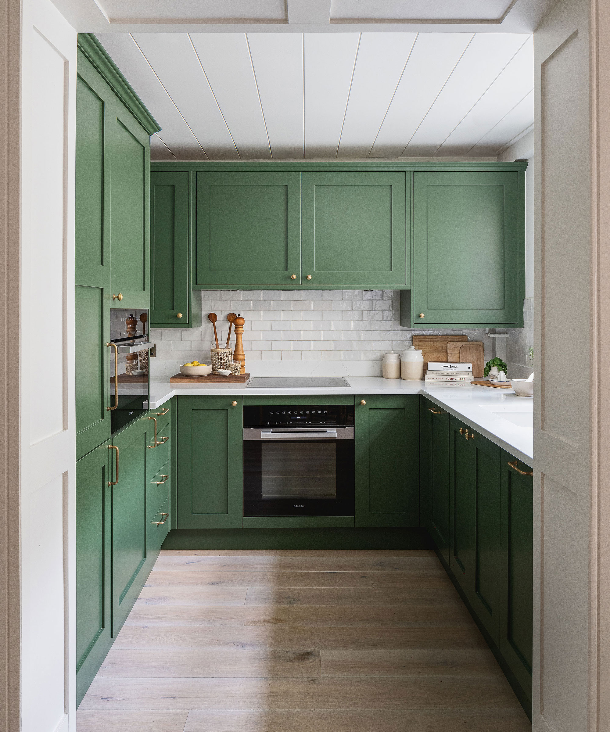 pea green Shaker kitchen with white oak flooring