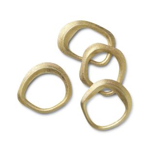 A set of four brass napkin rings