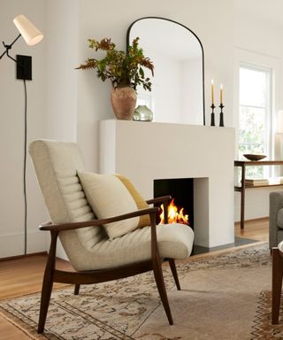 A cozy living room interior with fireplace and wall sconce