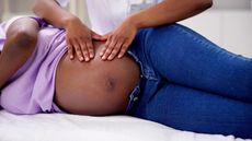 Prenatal massage on a Black belly