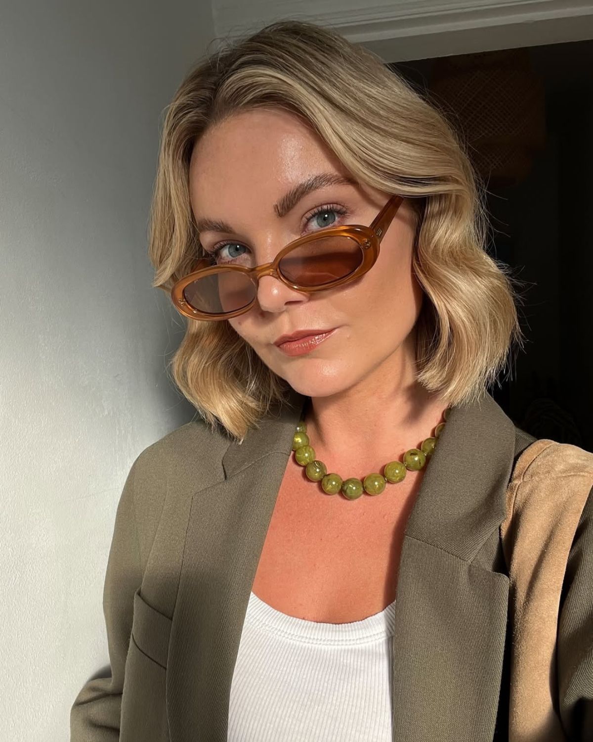 @ninaleacaine wears oval sunglasses and her hair in a relaxed Monaco Bob