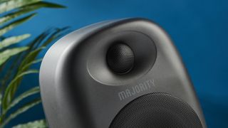 the majority d80 speakers, a pair of black egg-shaped speakers with mesh casing, HDMI, bluetooth, aux connectivity