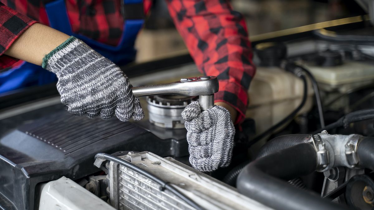 Mechanic working on car engine